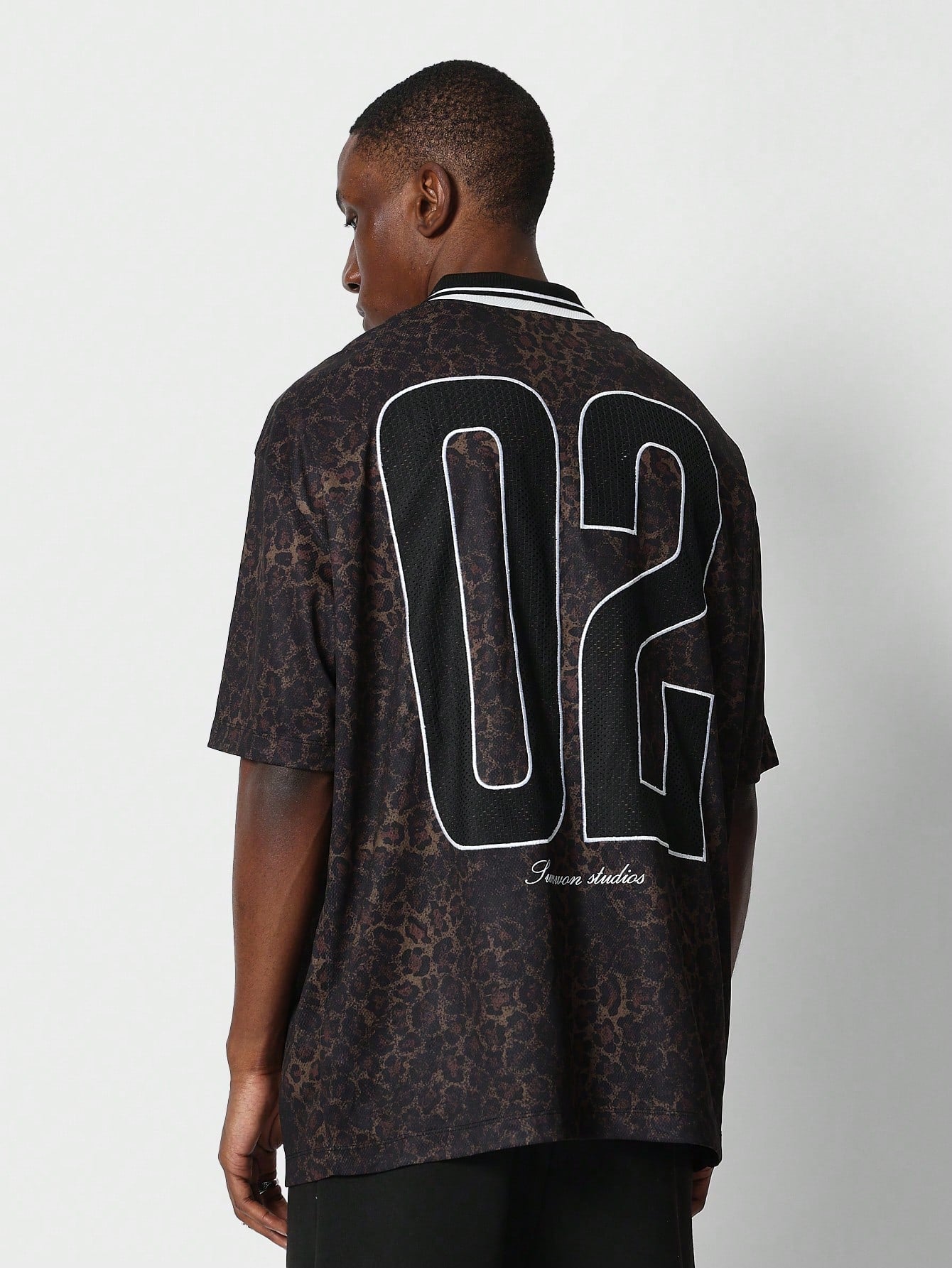 Oversized Fit Football Tee With All Over Leopard And Number Graphic Print