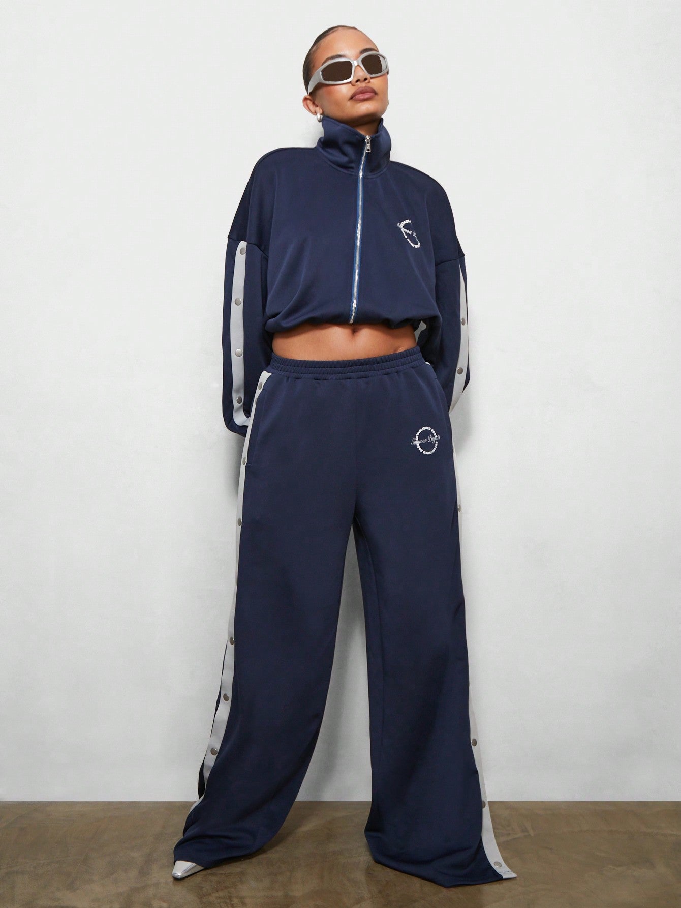 SUMWON WOMEN Wide Leg Side Popper Sweatpants With Contrast Panel & Small Letter Graphic Print