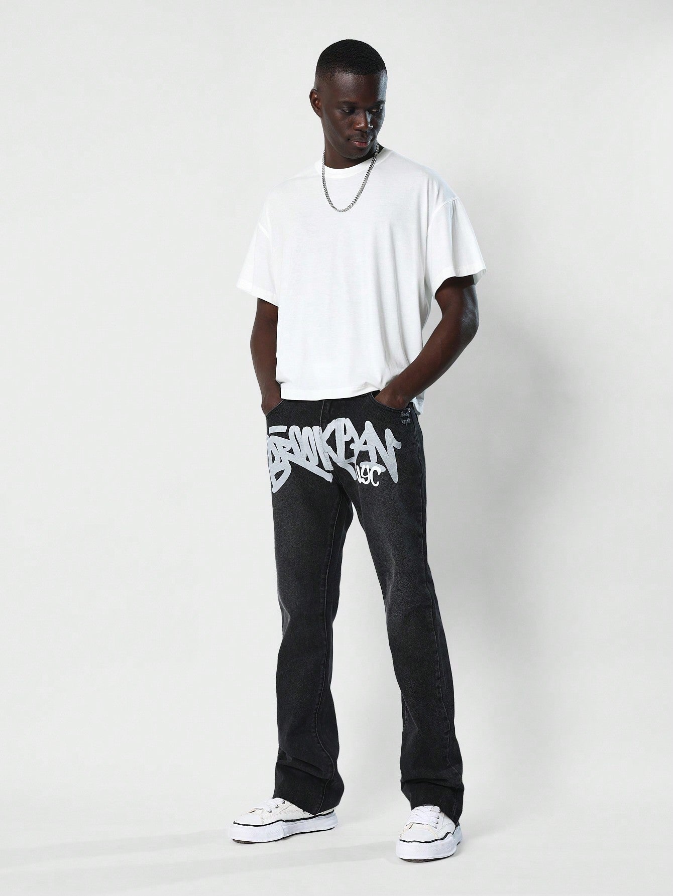 Flare Fit Washed Jean With Front Graphic Print & Distressed Detail At Th Back