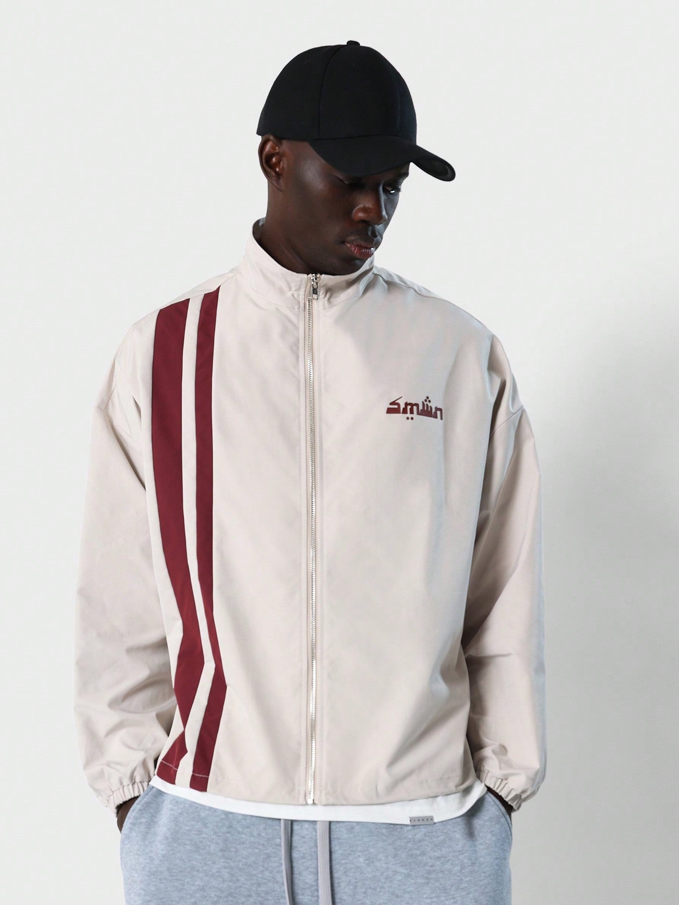 Sporty Nylon Mock Neck Zip Through Track Jacket With Side Stripe And Small Graphic Print